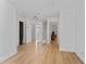 Hallway featuring hardwood floors, white walls, and open doorways to various rooms at 1425 Carey Glen Cir, Orlando, FL 32824