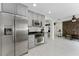Kitchen with gray cabinets, stainless steel appliances, and white tile floors at 1425 Carey Glen Cir, Orlando, FL 32824