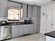 Well-equipped kitchen featuring stainless steel appliances, gray cabinetry, and a stylish backsplash at 1425 Carey Glen Cir, Orlando, FL 32824