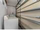 Laundry area with white washer and dryer, shelving unit, and concrete block wall at 1425 Carey Glen Cir, Orlando, FL 32824