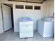 Laundry room featuring a washer and dryer with neutral wall and floor tiles at 1425 Carey Glen Cir, Orlando, FL 32824