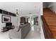 Bright living room with gray sofa, white tile floors, stairs, and stylish decor at 1425 Carey Glen Cir, Orlando, FL 32824