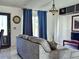 Inviting living room with blue curtains, a comfortable couch, and easy access to the entrance at 1425 Carey Glen Cir, Orlando, FL 32824