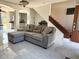 Cozy living space with a plush sectional sofa, modern tile flooring, and seamless flow to other rooms at 1425 Carey Glen Cir, Orlando, FL 32824