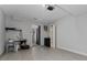 Uncluttered room with light wood-look flooring and an open doorway leading to a bathroom at 1425 Carey Glen Cir, Orlando, FL 32824