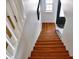 Wooden staircase with white railing leading to the upper level at 1425 Carey Glen Cir, Orlando, FL 32824