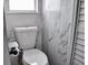 White toilet with marbled tiled walls and window at 1425 Carey Glen Cir, Orlando, FL 32824