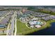 Aerial view of the neighborhood with pool, clubhouse, tennis courts and lake in view at 14309 Lanikai Beach Dr, Orlando, FL 32827