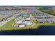 A beautiful aerial view of the community pool, tennis courts, and surrounding neighborhood at 14309 Lanikai Beach Dr, Orlando, FL 32827