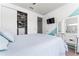 Well-lit bedroom features a queen bed, television, and sliding closet doors for optimal storage at 14309 Lanikai Beach Dr, Orlando, FL 32827