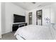 Cozy bedroom with large TV, open closet, and ensuite bathroom access at 14309 Lanikai Beach Dr, Orlando, FL 32827