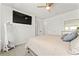 Light-filled bedroom with carpet floors, a ceiling fan, TV, and a comfortable queen-size bed at 14309 Lanikai Beach Dr, Orlando, FL 32827