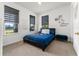 Cozy bedroom with a bed, window with blinds, and unique Mickey Mouse decor at 14309 Lanikai Beach Dr, Orlando, FL 32827