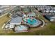 Aerial view of community pool and splash pad with pool house, seating, and green space at 14309 Lanikai Beach Dr, Orlando, FL 32827