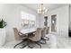 Bright dining area with modern lighting, a wooden table, and comfortable seating at 14309 Lanikai Beach Dr, Orlando, FL 32827