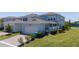 Exterior angle of home with a well-manicured lawn and attached garage in a residential neighborhood at 14309 Lanikai Beach Dr, Orlando, FL 32827