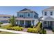 Two-story home featuring a welcoming front porch, manicured landscaping, and elegant architectural details at 14309 Lanikai Beach Dr, Orlando, FL 32827