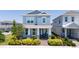 Charming two-story home with well-manicured landscaping and classic design, showcasing its inviting curb appeal at 14309 Lanikai Beach Dr, Orlando, FL 32827