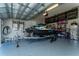 Spacious garage with epoxy flooring, ample storage, and a personal watercraft on a trailer at 14309 Lanikai Beach Dr, Orlando, FL 32827