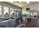 View of the fitness center featuring a weight machine, treadmill, and mirrored wall at 14309 Lanikai Beach Dr, Orlando, FL 32827