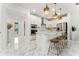 Bright, modern kitchen with stainless appliances, white cabinets, marble floors, and a stylish central island at 14309 Lanikai Beach Dr, Orlando, FL 32827