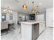 Modern kitchen showcasing stainless steel appliances, a marble-topped island, and an open layout with a dining area at 14309 Lanikai Beach Dr, Orlando, FL 32827