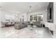 Spacious living room with stylish furniture, large windows, and a view of the backyard at 14309 Lanikai Beach Dr, Orlando, FL 32827