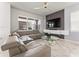 Comfortable living room with a modern sofa, unique coffee table, and a decorative wall at 14309 Lanikai Beach Dr, Orlando, FL 32827