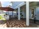 Covered patio with outdoor dining area, built-in grill, and ample seating and a hammock at 14309 Lanikai Beach Dr, Orlando, FL 32827