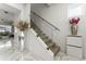 Elegant staircase with glass railing, marble floors, and tasteful decorations at 14309 Lanikai Beach Dr, Orlando, FL 32827