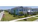 Street view showcasing a community of two-story homes with well-maintained lawns and inviting curb appeal at 14309 Lanikai Beach Dr, Orlando, FL 32827