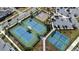 Aerial view of community tennis and basketball courts, with adjacent parking and playground nearby at 14309 Lanikai Beach Dr, Orlando, FL 32827