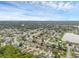 A scenic aerial view showcasing homes near a lake, featuring lush greenery and tidy lawns in a well-planned neighborhood at 1436 Nolton Way, Orlando, FL 32822