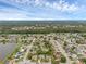 Expansive aerial view of a neighborhood with mature trees and well-maintained homes under a partly cloudy sky at 1436 Nolton Way, Orlando, FL 32822
