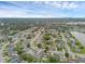 Expansive aerial view of a residential neighborhood with lush greenery, nearby lake, and clear blue skies at 1436 Nolton Way, Orlando, FL 32822