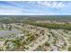 Aerial view featuring a serene lake surrounded by well-kept homes with lush landscaping under a partly cloudy sky at 1436 Nolton Way, Orlando, FL 32822