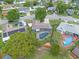 Aerial showcases a backyard with a screened pool, lush landscaping, and fenced yard at 1436 Nolton Way, Orlando, FL 32822