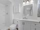 Well-lit bathroom featuring a shower, toilet, vanity, and mirror with ample storage at 1436 Nolton Way, Orlando, FL 32822