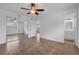A spacious bedroom with mirrored closet doors, ceiling fan, and tile flooring at 1436 Nolton Way, Orlando, FL 32822