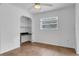 Bright bedroom features a ceiling fan, a built-in desk and shelving, and a window for natural light at 1436 Nolton Way, Orlando, FL 32822