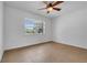 Well-lit bedroom featuring tile flooring, a ceiling fan, and a window offering views at 1436 Nolton Way, Orlando, FL 32822