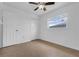 This bedroom features neutral walls, tile floors, a ceiling fan, a window, and two closets at 1436 Nolton Way, Orlando, FL 32822