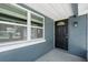 Welcoming entryway featuring a black front door with sidelight and a window offering ample natural light at 1436 Nolton Way, Orlando, FL 32822