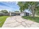 Charming single-story home with a cracked circular driveway, lush lawn, and a two-car garage at 1436 Nolton Way, Orlando, FL 32822