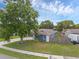 A charming single-story home with a well-manicured lawn and mature tree providing ample shade at 1436 Nolton Way, Orlando, FL 32822