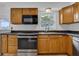 Modern kitchen features stainless steel appliances, wooden cabinets, and sleek countertops at 1436 Nolton Way, Orlando, FL 32822