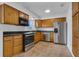 Well-equipped kitchen with stainless steel appliances, tiled floor, and wood cabinetry at 1436 Nolton Way, Orlando, FL 32822