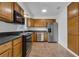 Modern kitchen features stainless steel appliances, granite countertops, and wooden cabinets at 1436 Nolton Way, Orlando, FL 32822