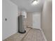 The laundry room has a water heater, tile floors, and wainscotting on the walls at 1436 Nolton Way, Orlando, FL 32822
