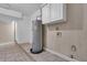 The laundry room features a water heater, tile floors, wainscotting, and a cabinet at 1436 Nolton Way, Orlando, FL 32822